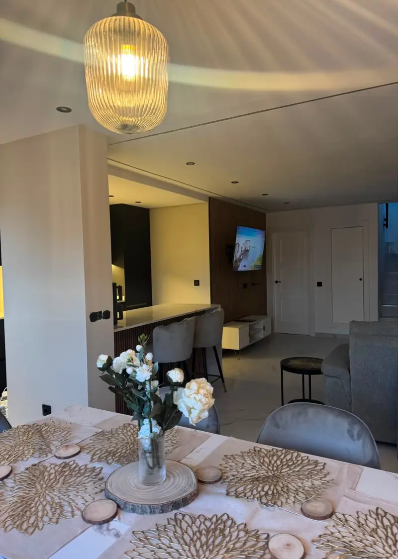Modern dining area lit by a statement ribbed-glass pendant lamp