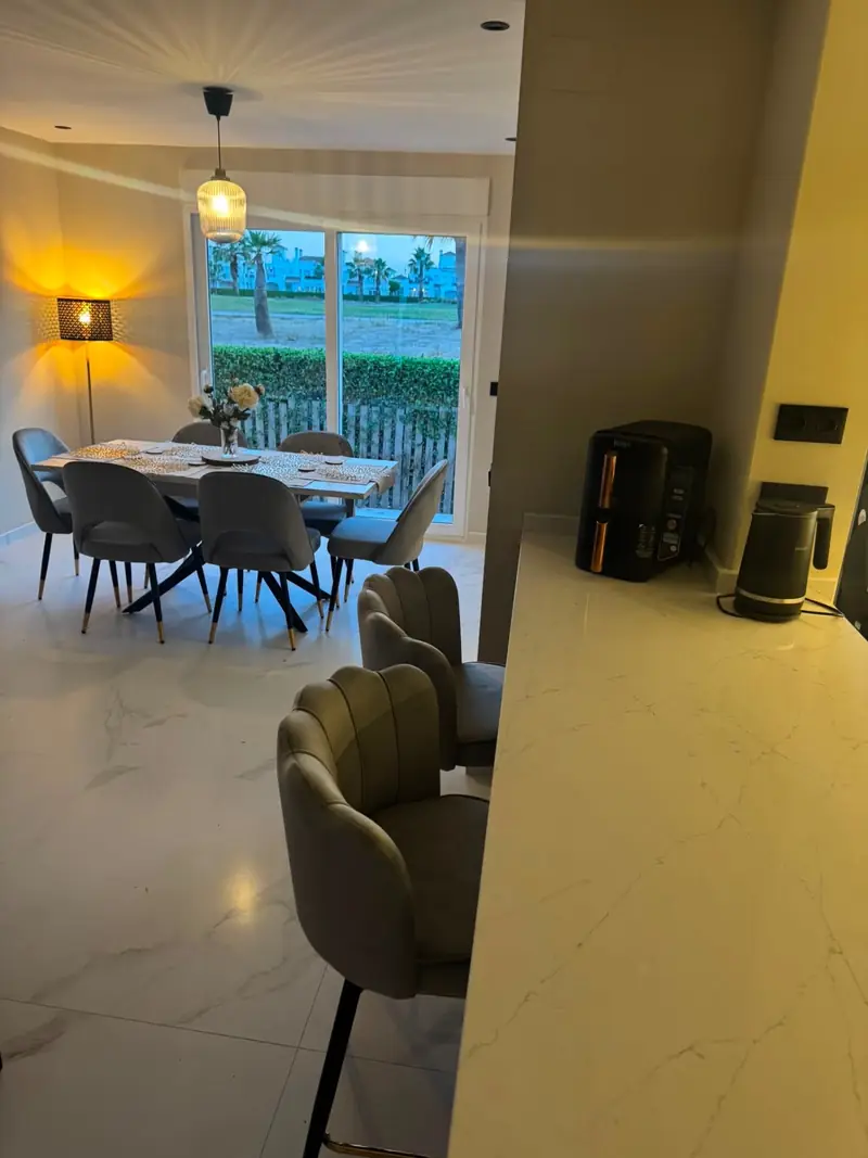 Marble breakfast bar looking through to the dining area and palm-lined fairway