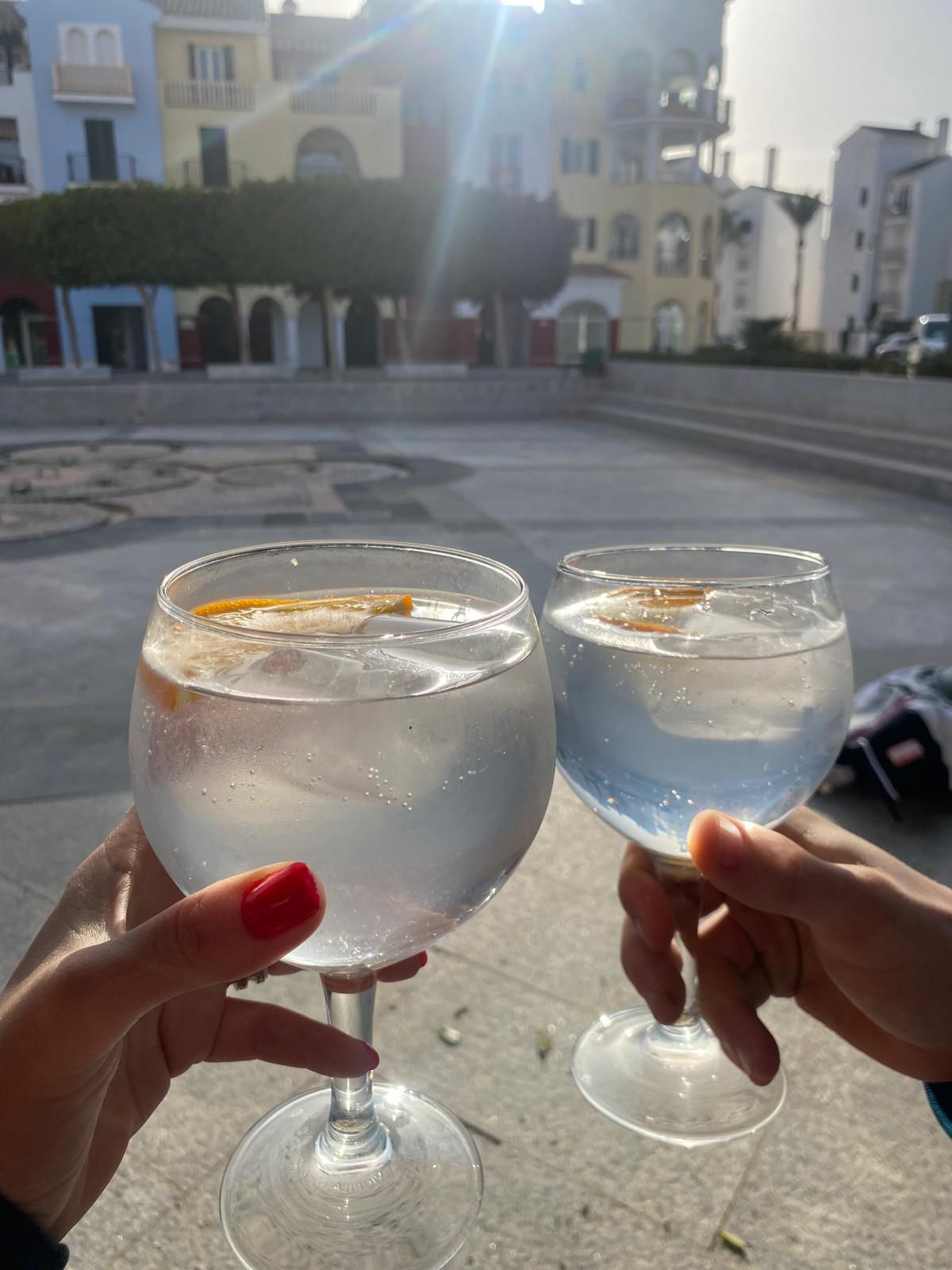 Gin and tonic served on a terrace table at sunset on the resort